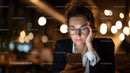 Young Woman Using Smartphone in Cozy Night Setting