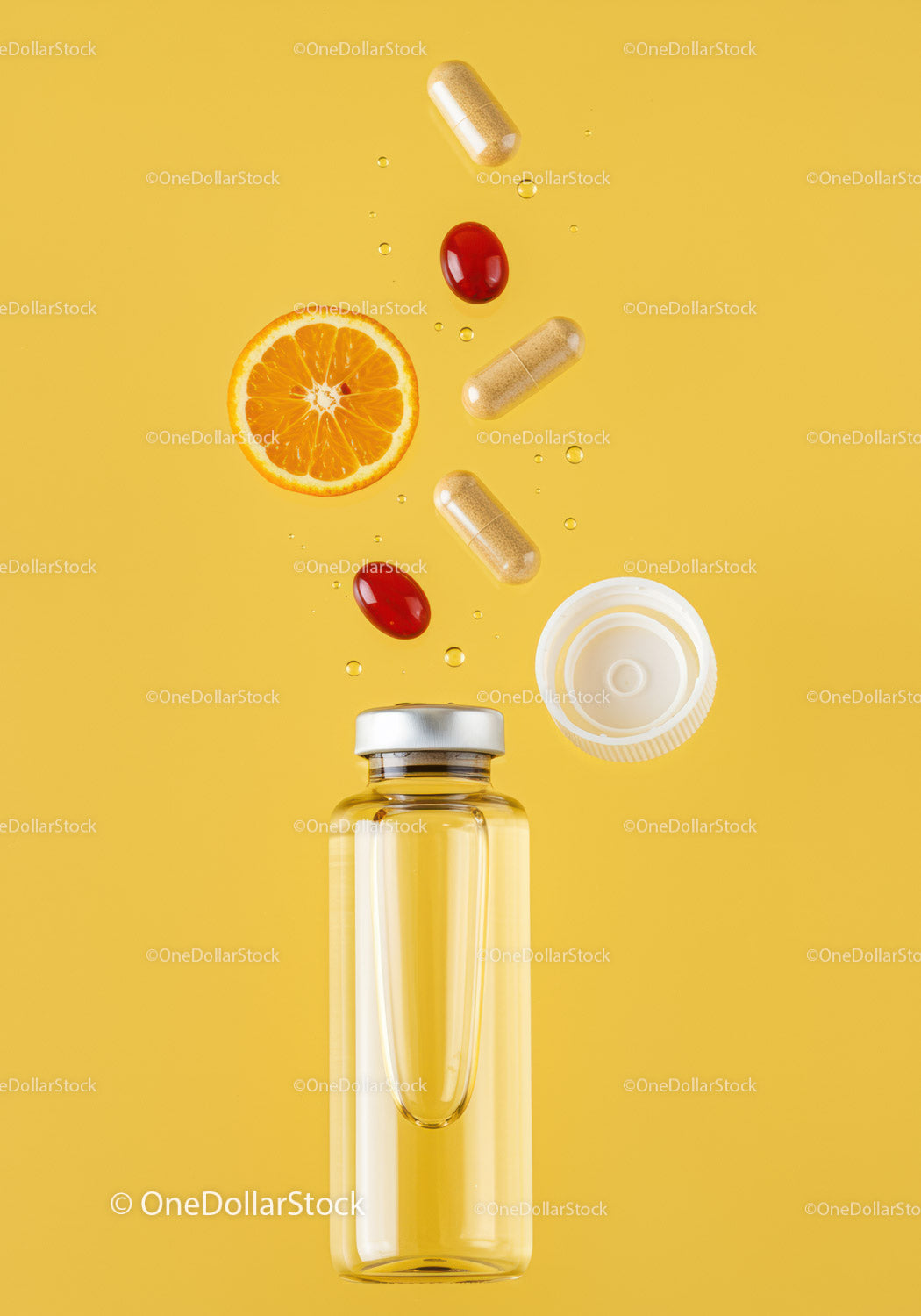 Supplements and fresh orange slice with liquid bottle