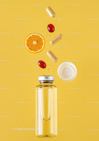 Supplements and fresh orange slice with liquid bottle