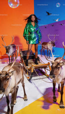 Confident woman in metallic coat with reindeer sleigh