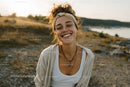 Smiling Woman in Casual Summer Outfit on Beach with Ocean View