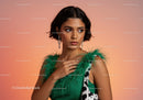 Fashion Portrait of a Young Woman Wearing a Green Feathered Top