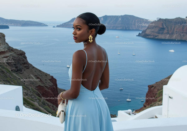 Elegant woman in blue dress overlooking sea view