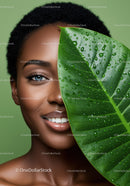 Bright Beautiful Woman with Green Leaf and Water Droplets