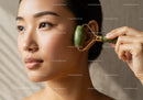 Young Woman Engaged in Facial Skincare Routine with Jade Roller