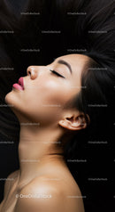 Serene young woman with closed eyes and flowing hair
