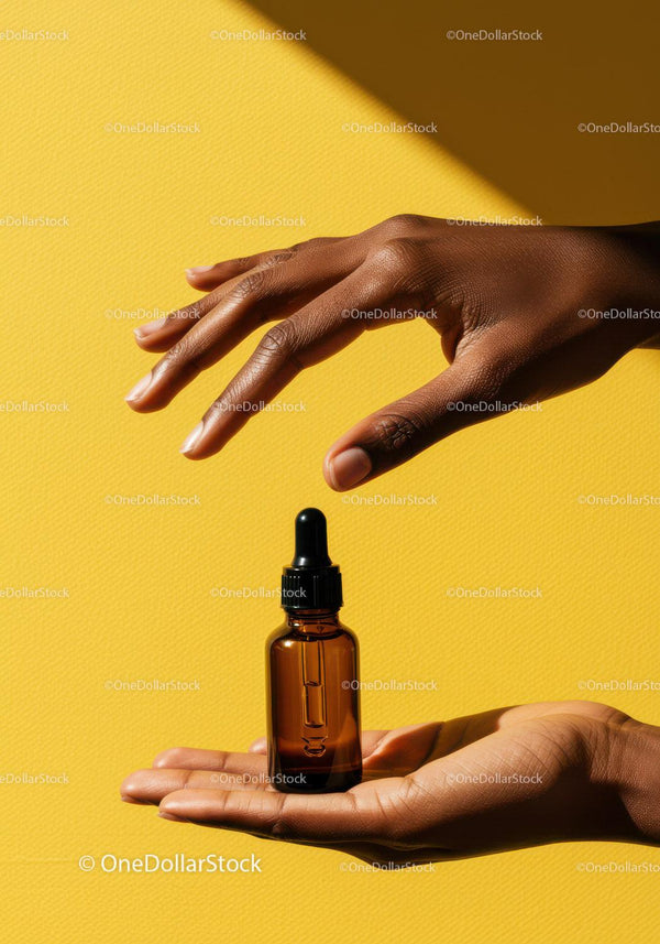 Elegant Hand Holding Brown Skincare Dropper Bottle on Yellow Background JPG Mockup Image