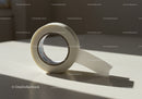 Roll of transparent adhesive tape on bright surface