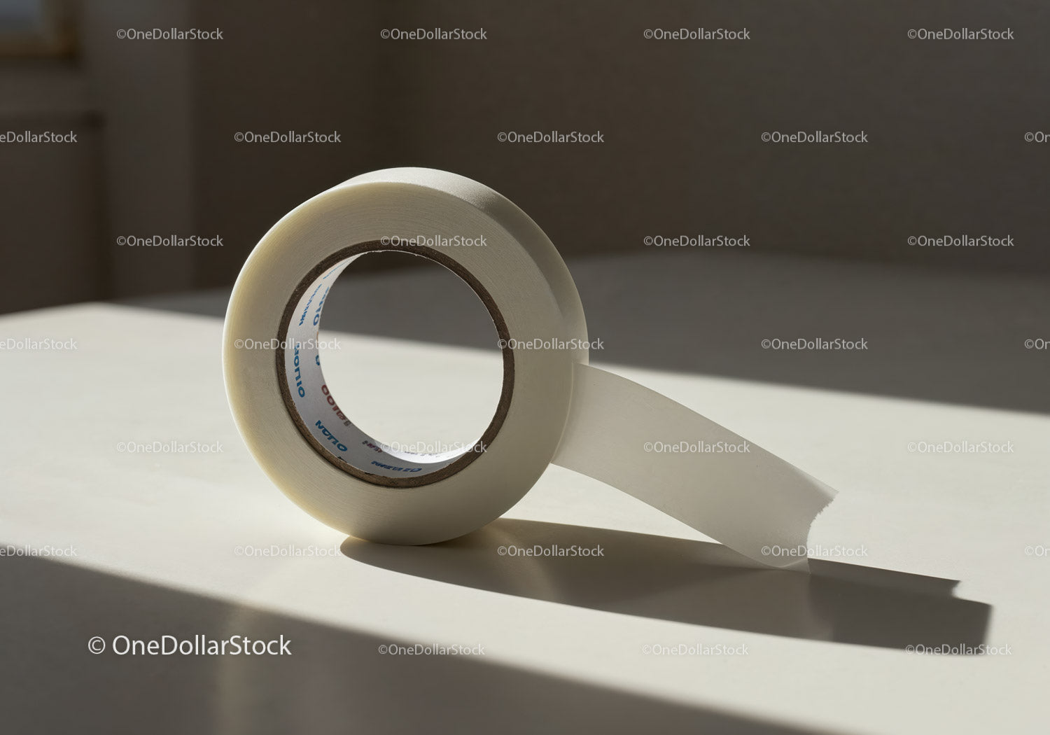 Roll of transparent adhesive tape on bright surface