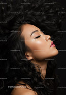 Profile of serene woman with flowing black hair