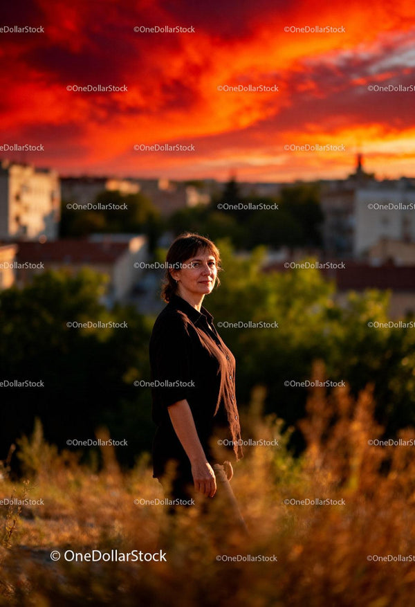 Woman enjoying warm sunset in natural urban setting