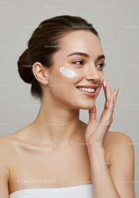 Young Woman Applying Skincare Cream for Healthy Glowing Skin