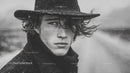 Male Model in Black Coat with Wet Hair in Rainy Outdoor Setting