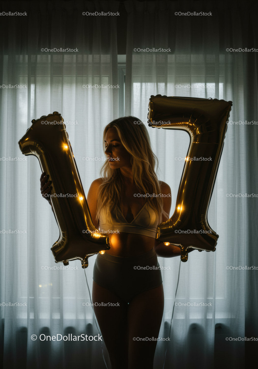 Woman holding illuminated gold 17 balloons indoors