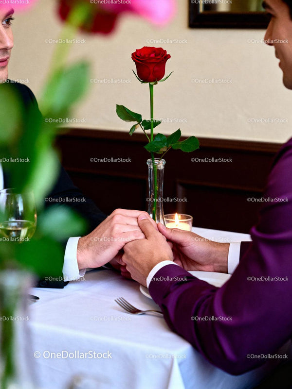 Romantic Couple Holding Hands Over Dinner Table