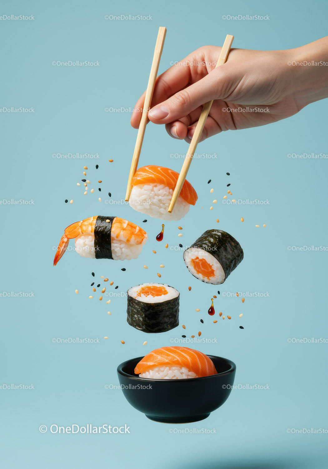 Sushi trzymane w dłoniach z pałeczkami i latającymi ziarnami sezamu