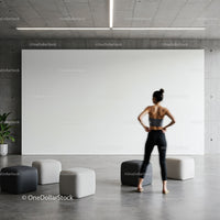 Woman standing in modern minimalist room with poufs
