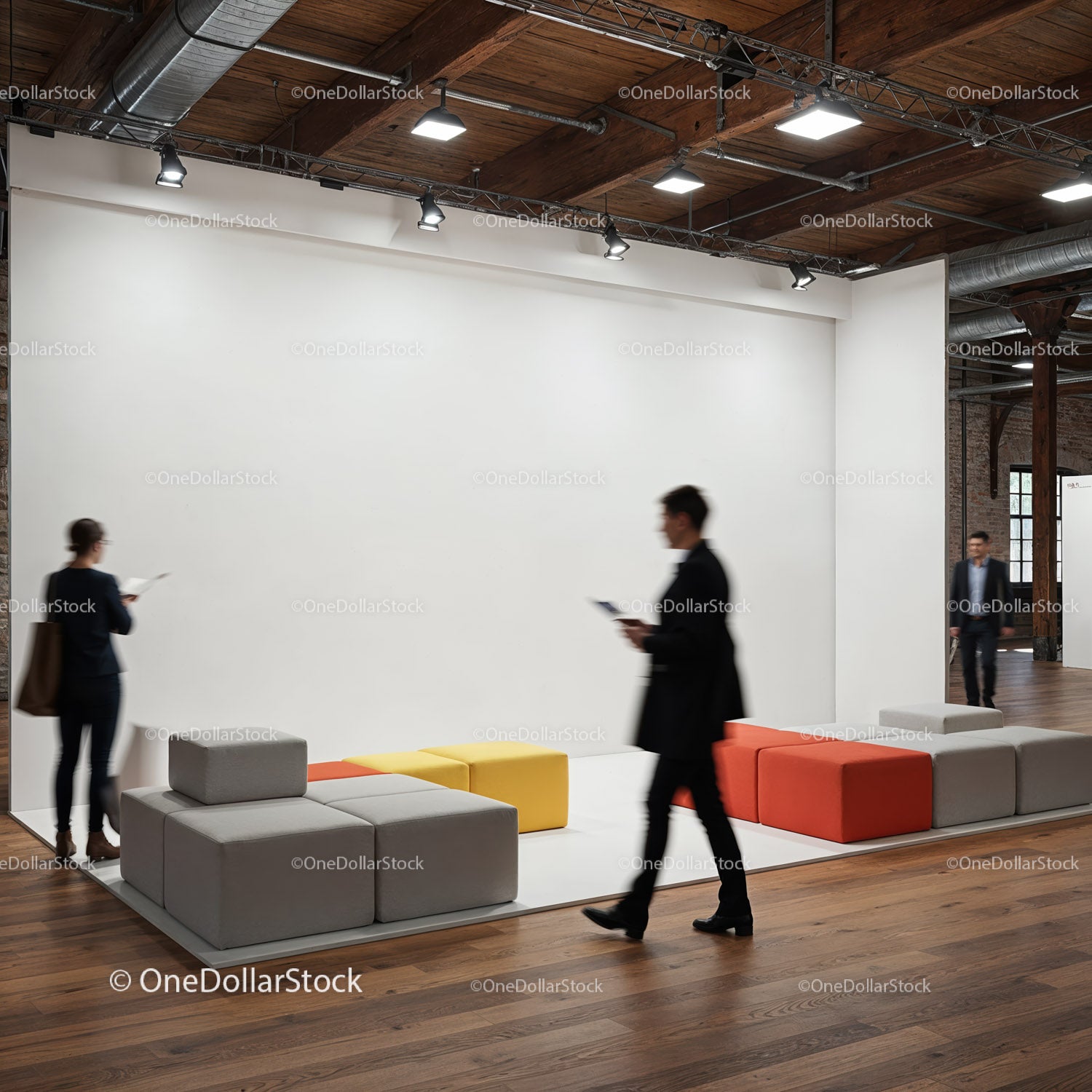 Modern office lounge area with people walking by