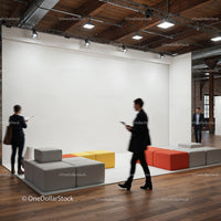 Modern office lounge area with people walking by