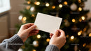 Person Holding Blank Card Near Christmas Tree Lights JPG Mockup Image preview