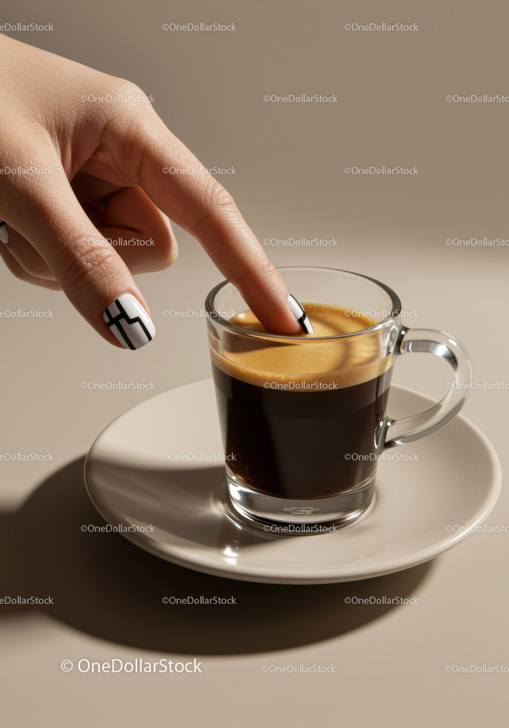 Fingers Touching Creamy Espresso in Glass Cup