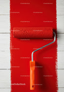 Red Wall Being Painted with Paint Roller for Home Renovation
