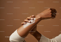 Elegant Hand with Moisturizing Lotion Applied Against Solid Color Background