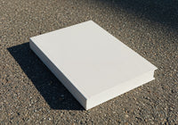 Blank white book on rough outdoor pavement surface