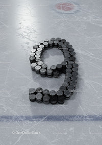 Hockey pucks arranged as number nine on ice rink