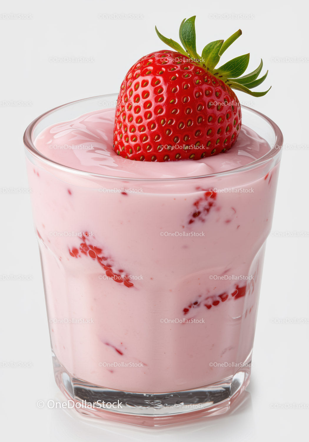 Fresh strawberry yogurt in a clear glass with berry