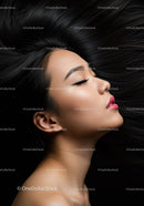 Serene young woman with flowing black hair profile