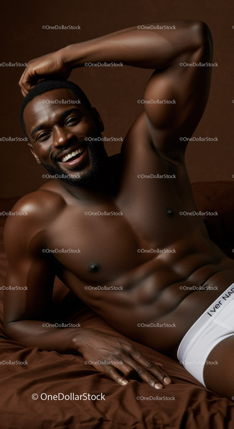 Smiling athletic man relaxing on brown bed linens