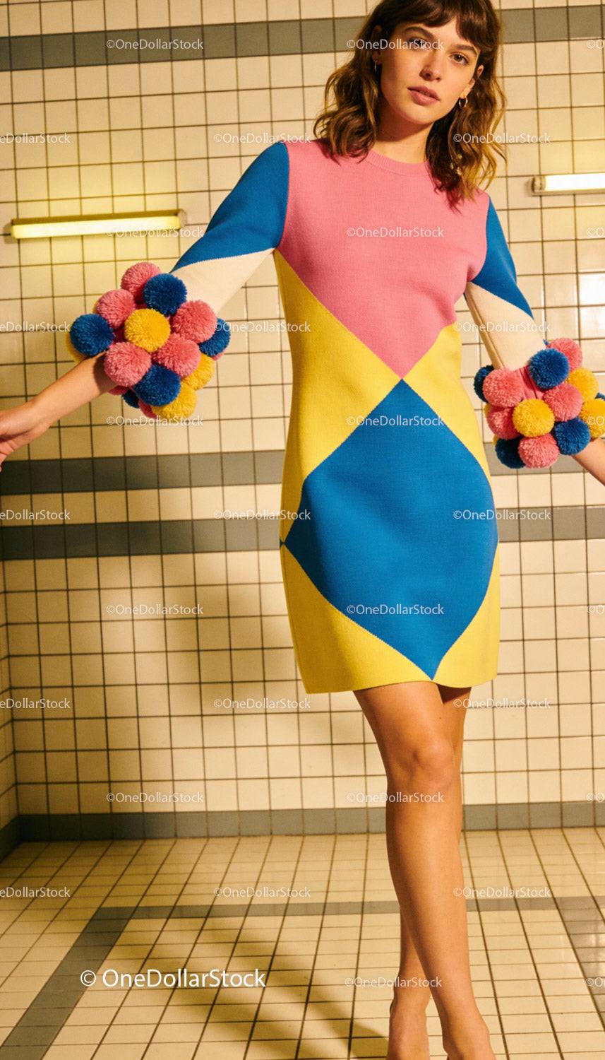 Colorful geometric knit dress with playful pompom sleeves
