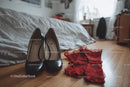 Chic Black Heels and a Red Lace Dress in a Cozy Bedroom Setting
