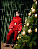 Elegant woman in red outfit near Christmas tree