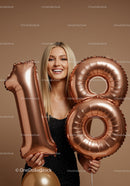 Smiling Young Woman Holding 18th Birthday Balloons