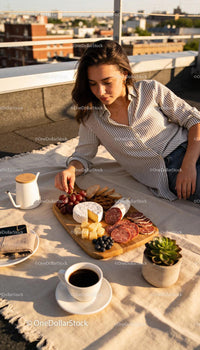 Woman enjoying a relaxed outdoor charcuterie board picnic