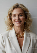 Elegant Smiling Woman in White Blazer with Gold Jewelry