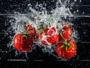 Ripe Red Cherry Tomatoes Falling into Water with Splash Effect