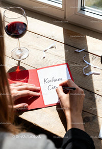 Woman Writing Love Note with Glass of Red Wine