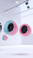 Vibrant Pink and Blue Spherical Wireless Speakers in Modern Setting