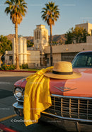 Vintage Pink Car with Straw Hat and Yellow Dress Fabric in Sunset