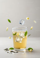 Refreshing iced jasmine tea with blossoms and green leaves