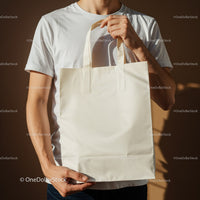 Man Holding Blank Eco Friendly Tote Bag in White Shirt