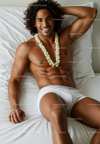Smiling man relaxing on bed with flower necklace