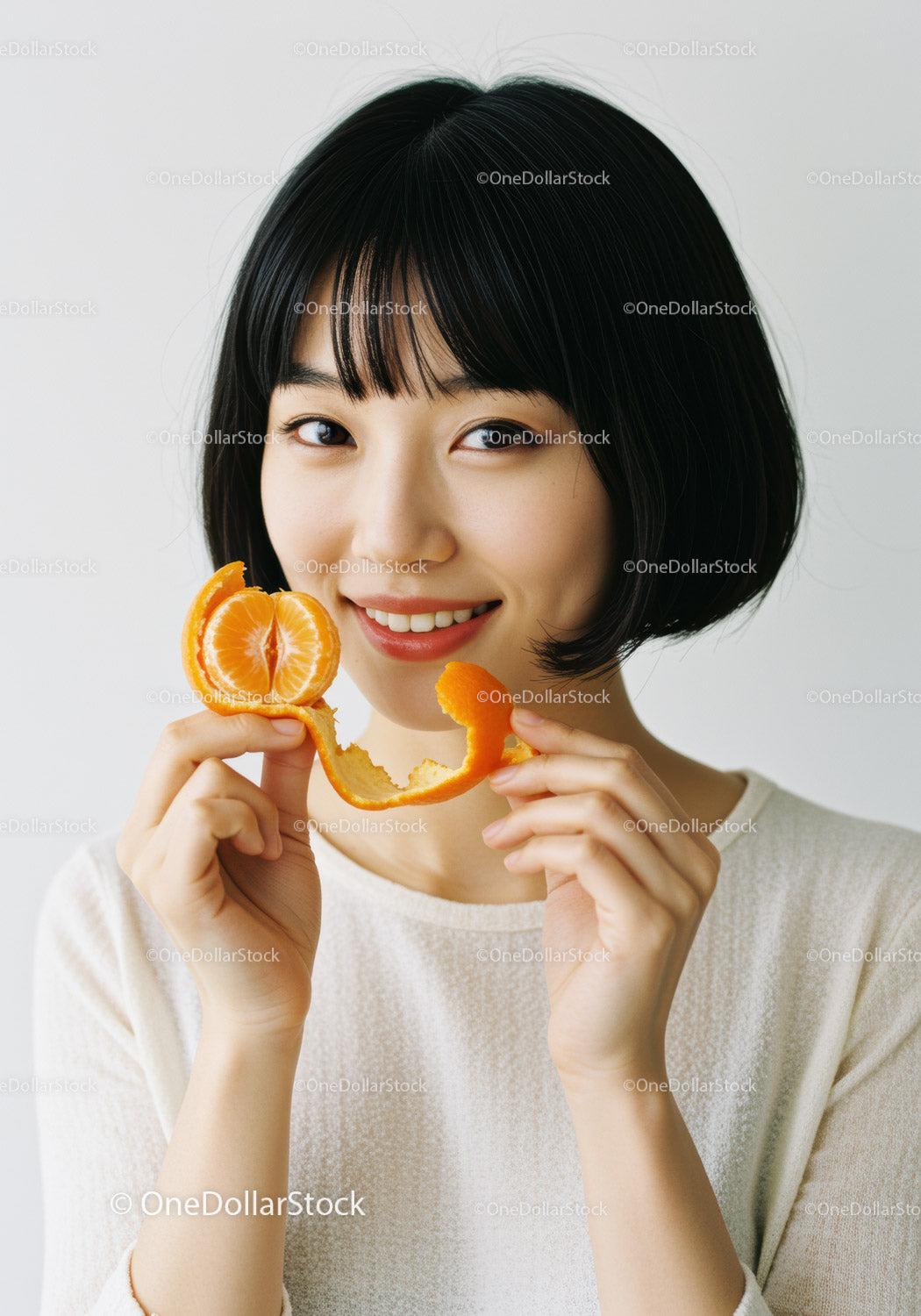Young Woman with Tangerine and Orange Peel in Bright Studio