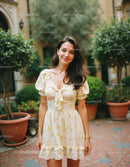 Woman in Beige Floral Dress Smiling in Garden Setting