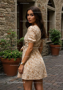 Elegant Young Woman in Floral Dress Standing on City Street