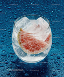 Refreshing Citrus Fruit and Ice in Glass on Wet Surface