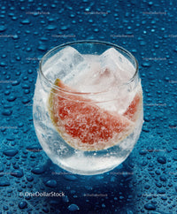 Refreshing Citrus Fruit and Ice in Glass on Wet Surface